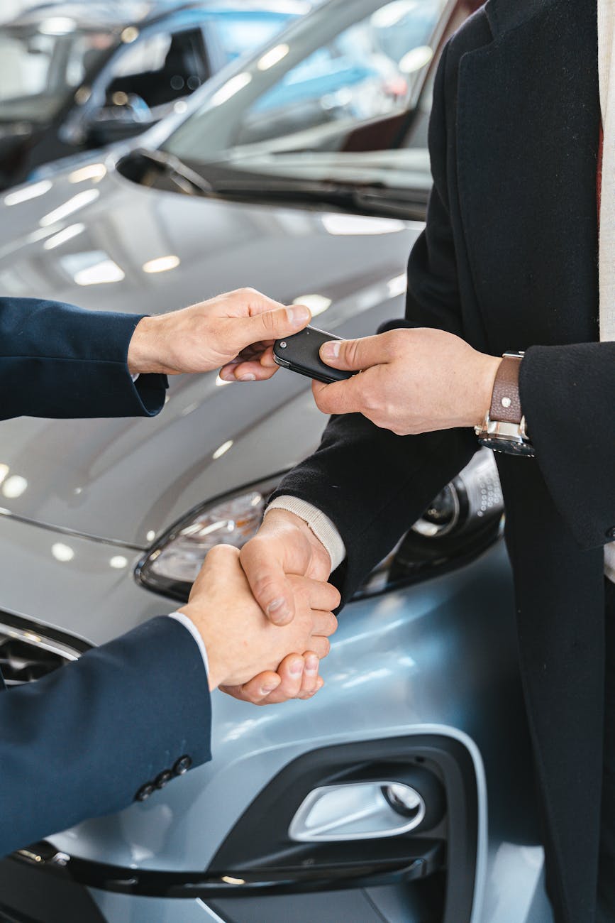 Photo by Antoni Shkraba on <a href="https://www.pexels.com/photo/close-up-of-men-shaking-hands-and-handing-in-keys-to-a-new-car-at-the-car-salon-7144212/" rel="nofollow">Pexels.com</a>
